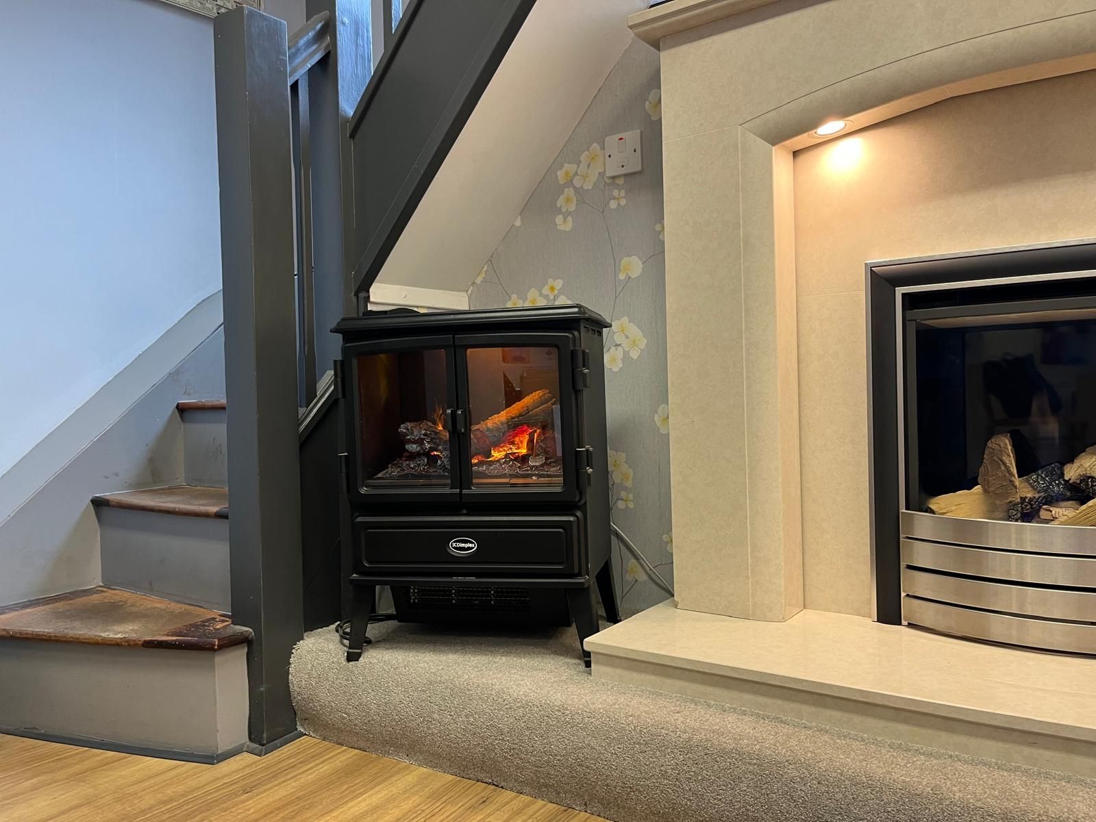 There is a fireplace and a stove in the living room.