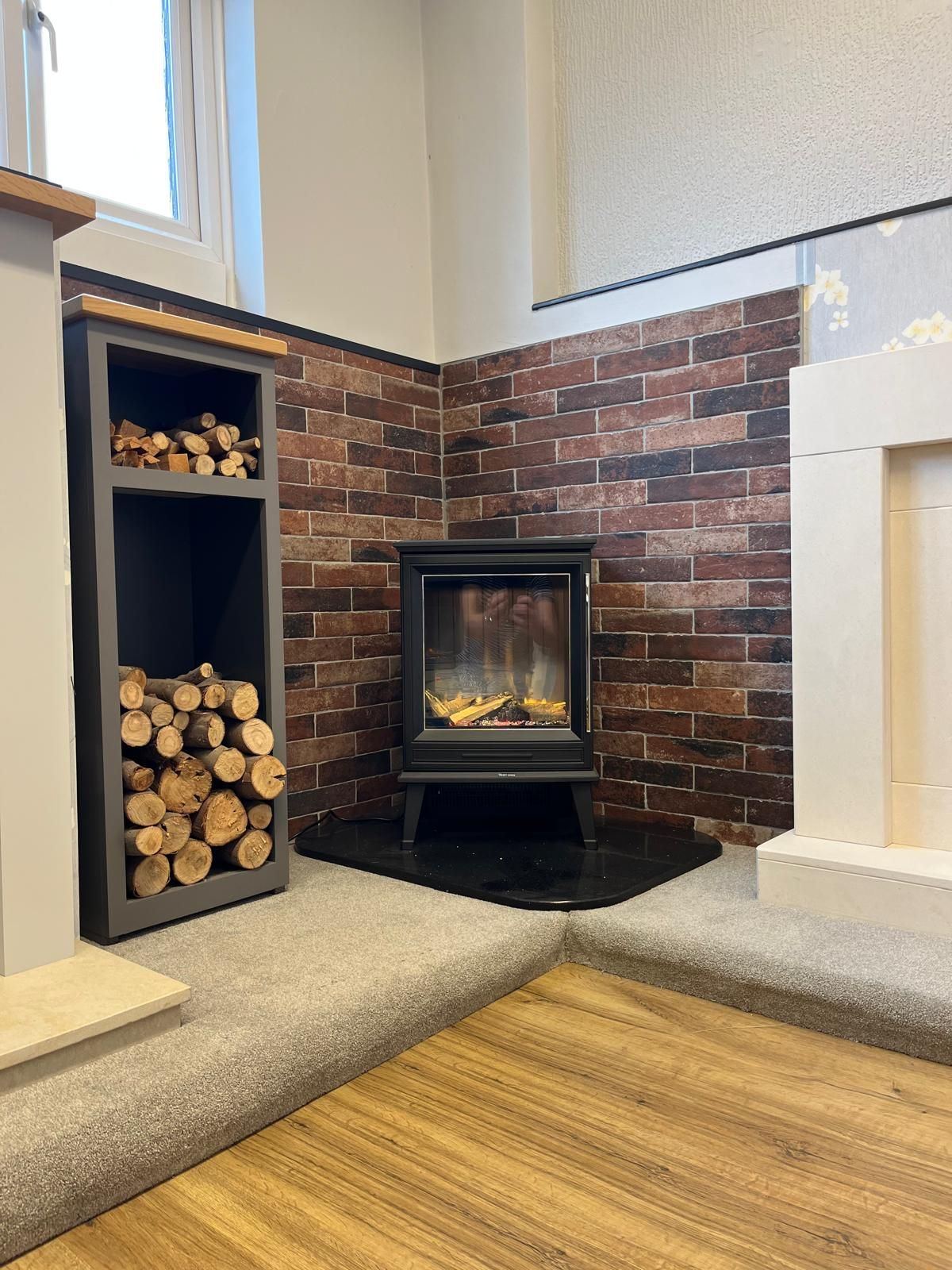 There is a fireplace in the corner of the room.