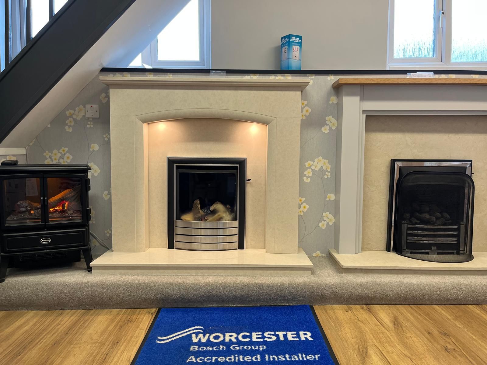 A fireplace with a blue rug that says worcester on it