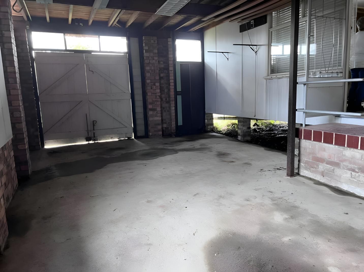 Empty Garage With Concrete Floor and Two Doors — LD Carpentry in Canberra, ACT
