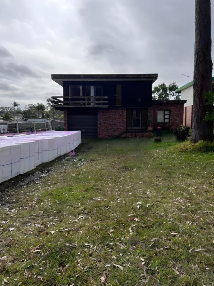 Two-story Brick Home Under a Cloudy Sky — LD Carpentry in Queanbeyan, NSW