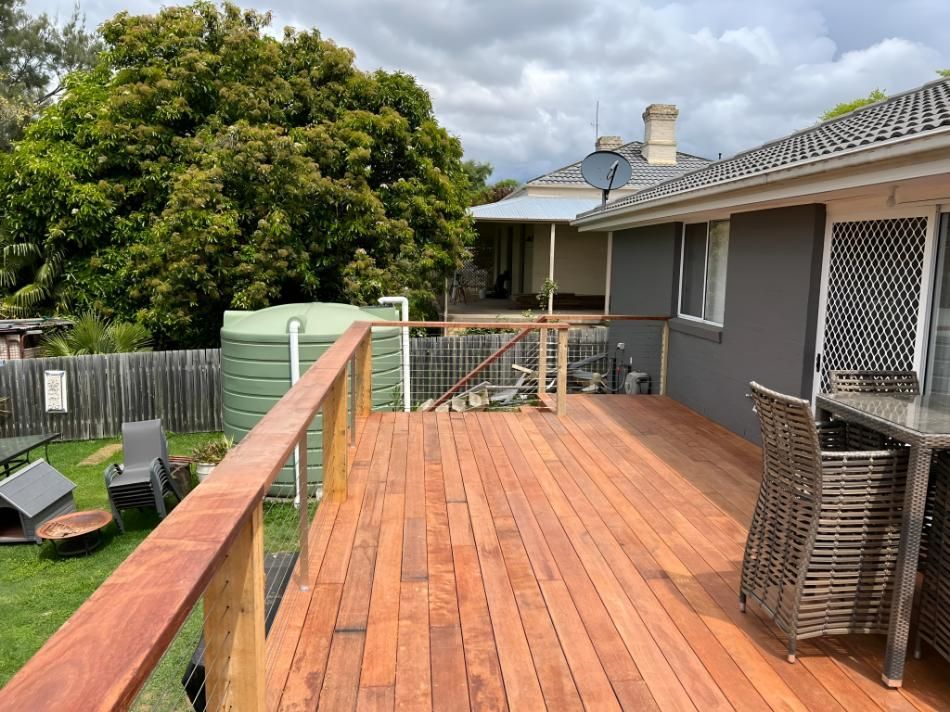 Wooden Deck Extending From a Gray House — LD Carpentry in Queanbeyan, NSW