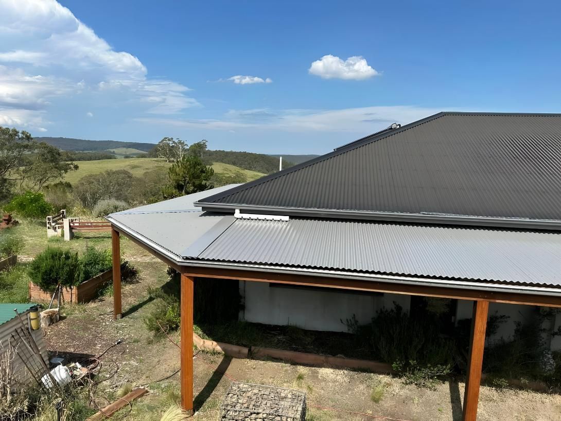 House With a Gray Corrugated Metal Roof — LD Carpentry in Goulburn, NSW