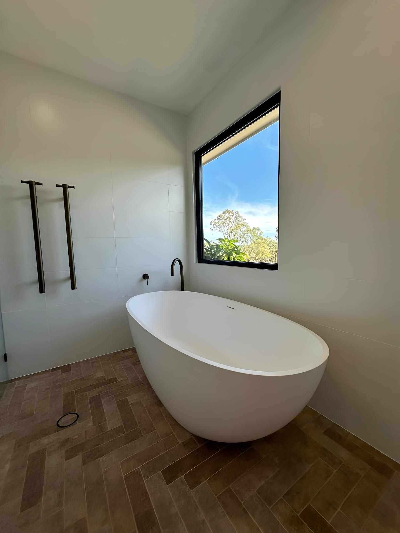 Bathroom With a White Oval Tub — LD Carpentry in Canberra, ACT