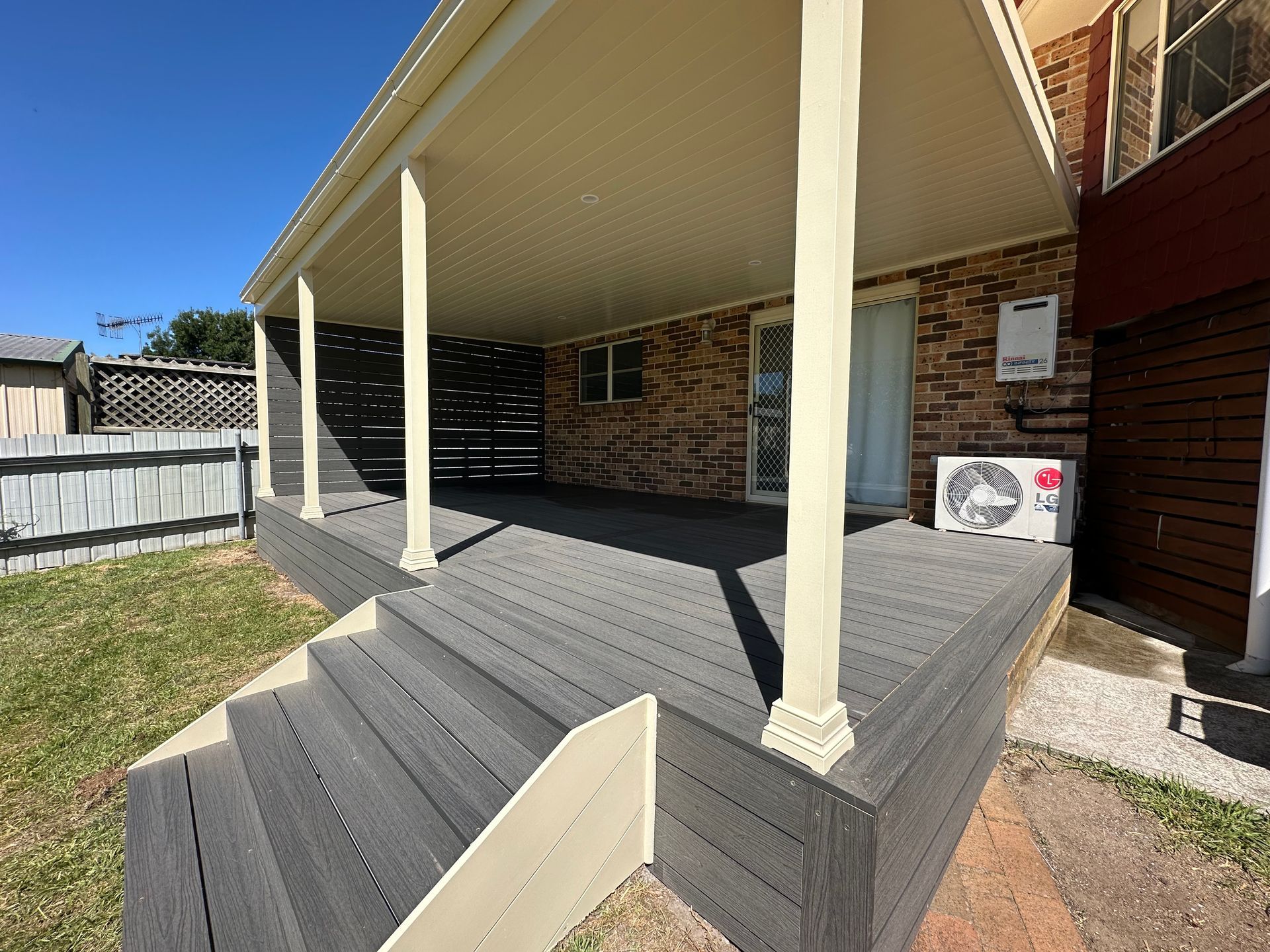 A covered wooden deck with steps, attached to a brick building — LD Carpentry in Goulburn, NSW