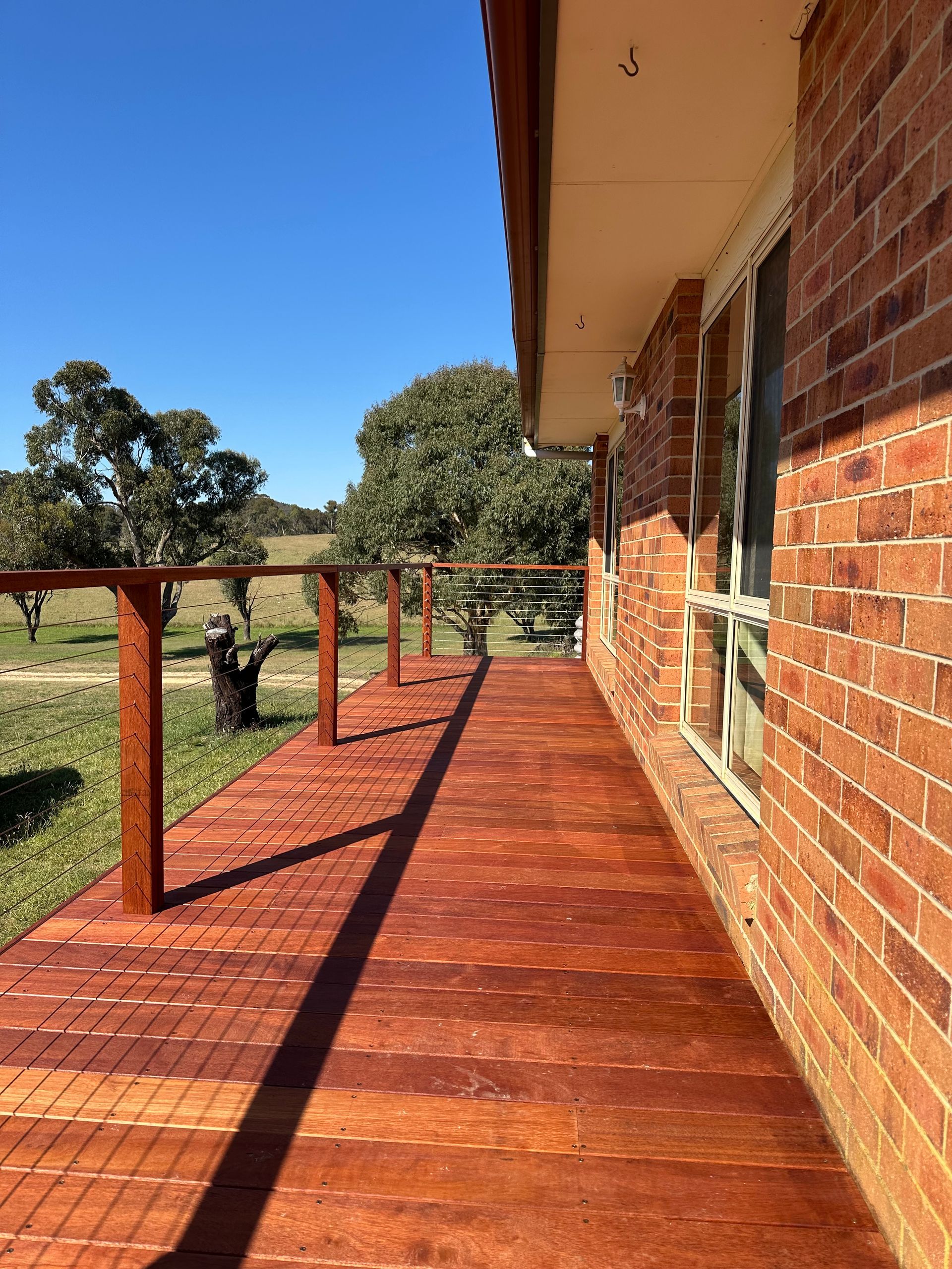 Single-story House With a Dark Roof, Surrounded by a Wooden deck — LD Carpentry in Goulburn, NSW