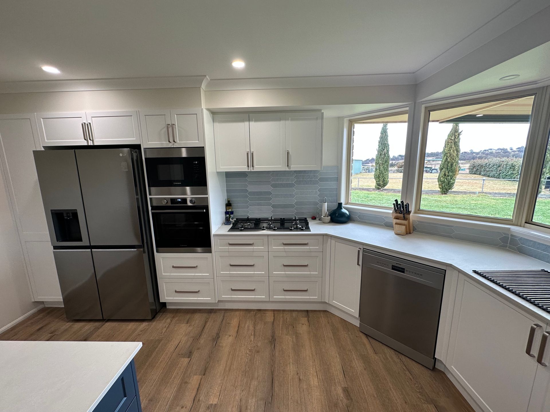 Modern white kitchen with stainless steel appliances — LD Carpentry in Goulburn, NSW