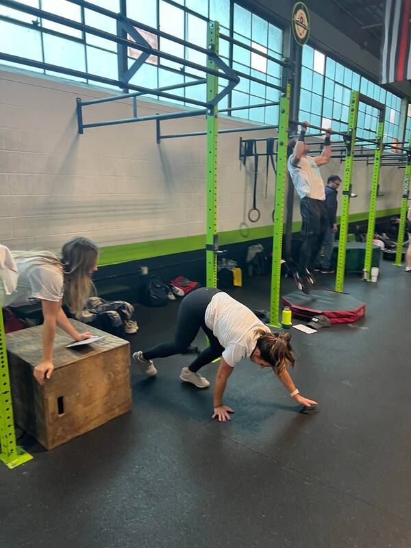A group of people are doing exercises in a gym.
