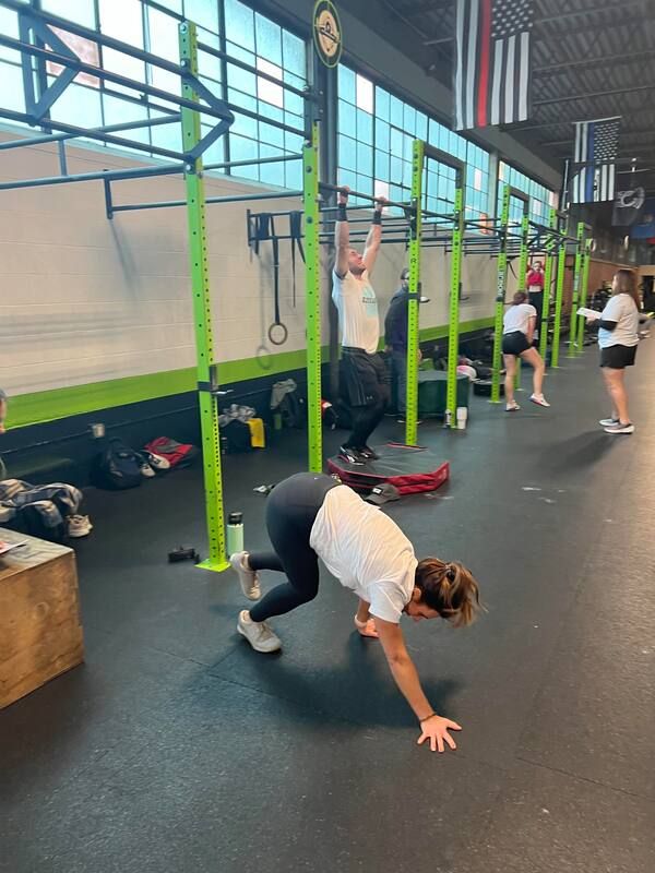 A group of people are doing exercises in a gym.