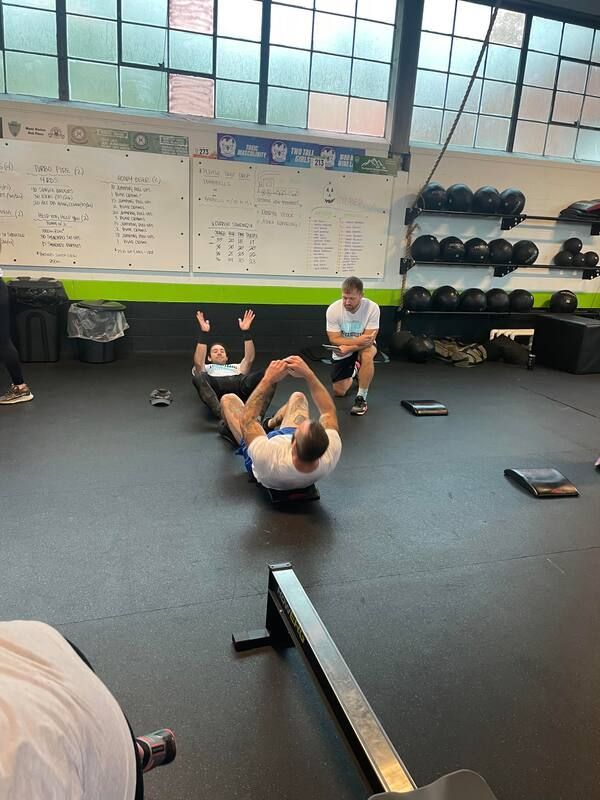 A group of people are doing exercises in a gym.
