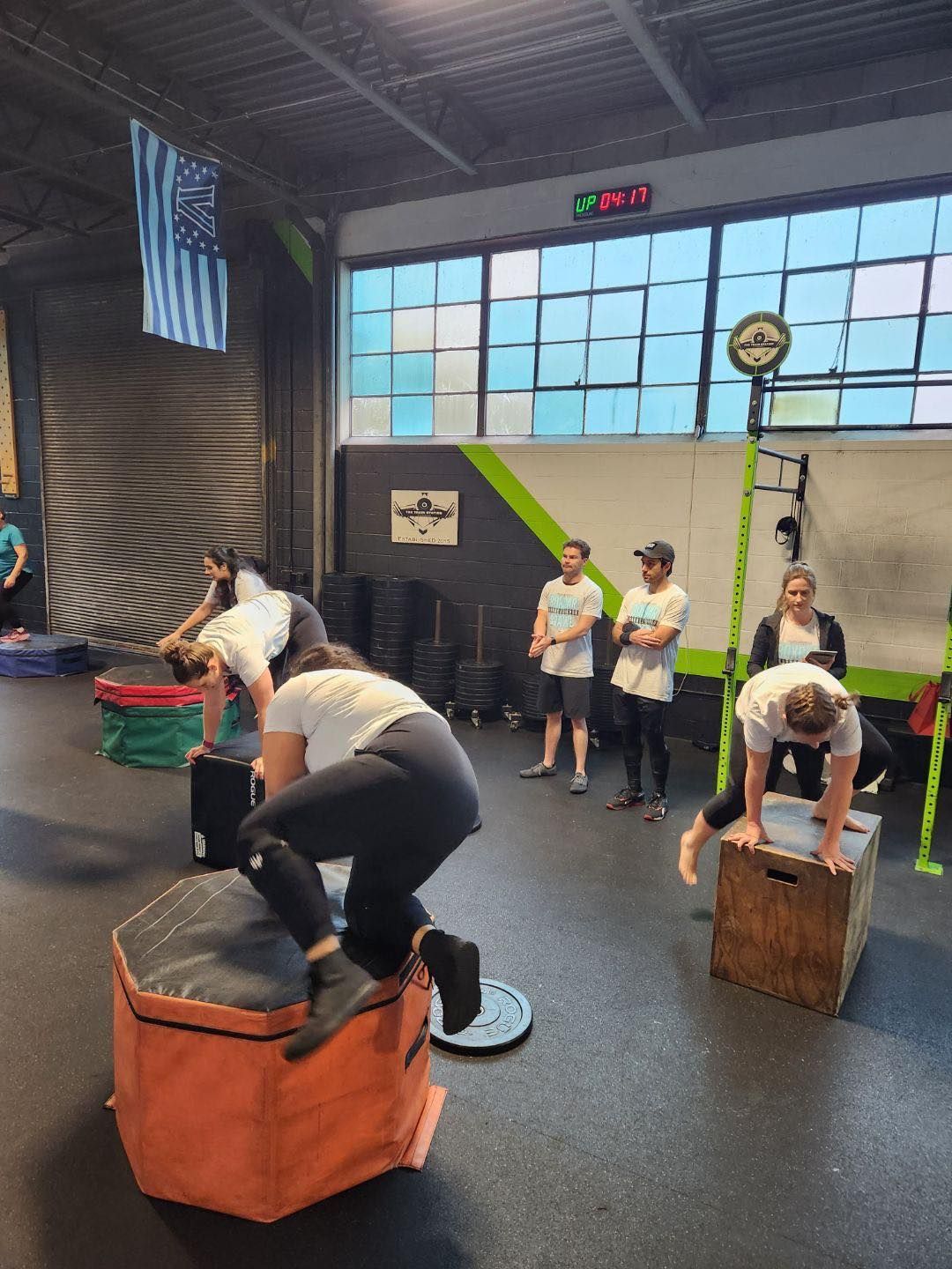 A group of people are doing exercises in a gym.