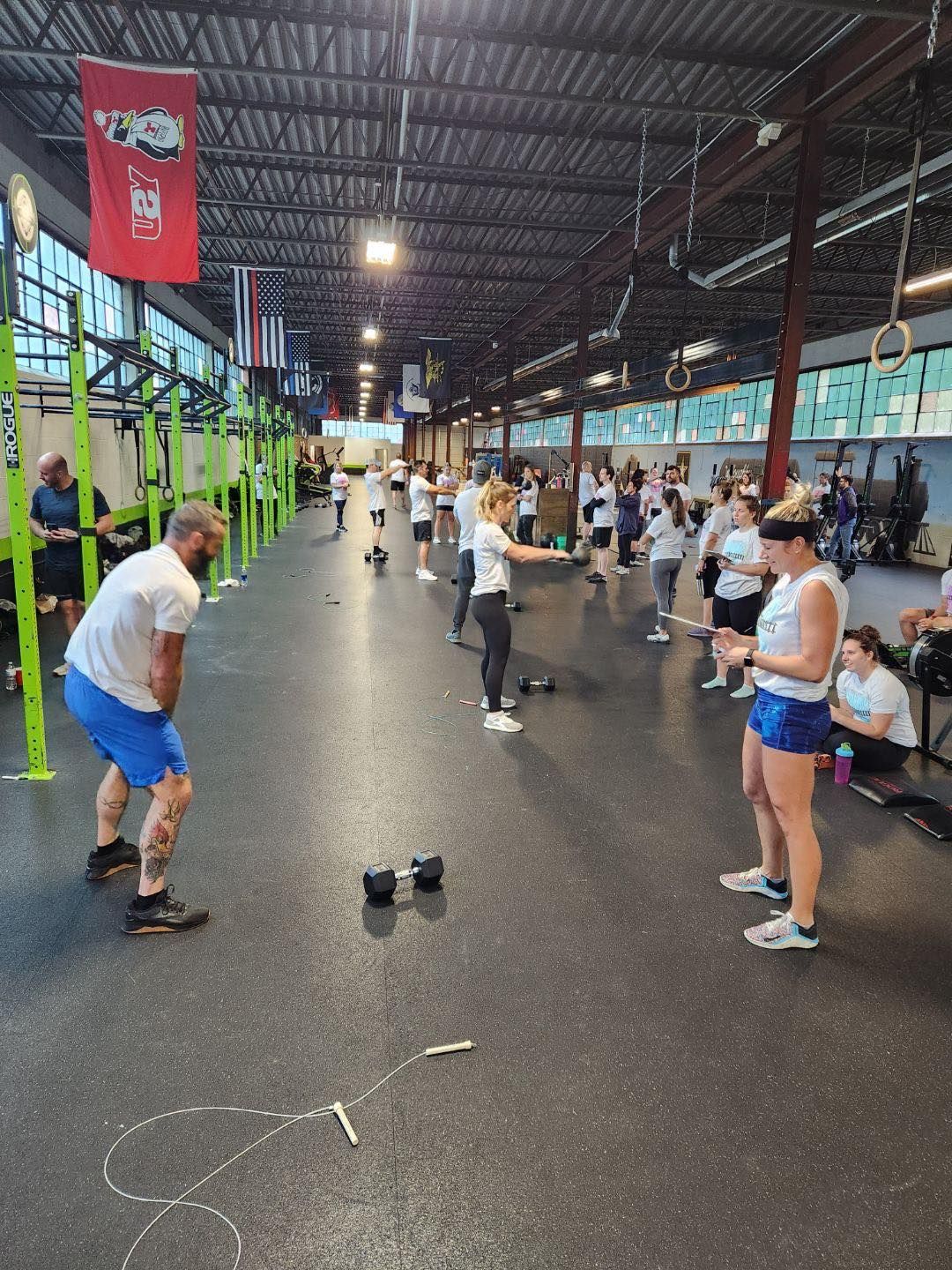 A group of people are doing exercises in a gym.