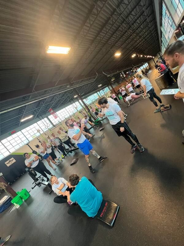 A group of people are doing exercises in a gym.