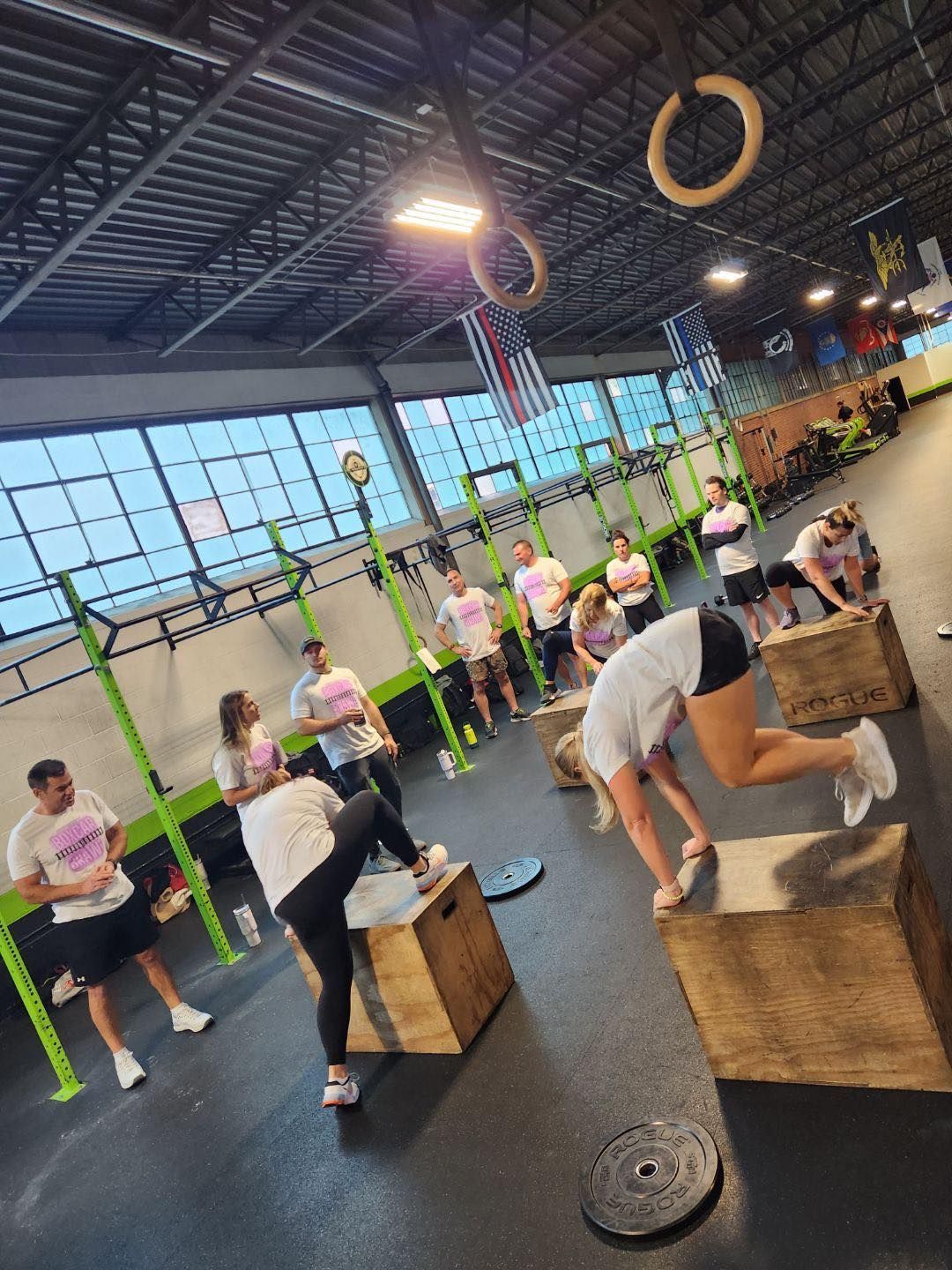 A group of people are doing exercises in a gym.