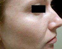 A close up of a woman 's face with a black square over her eyes.