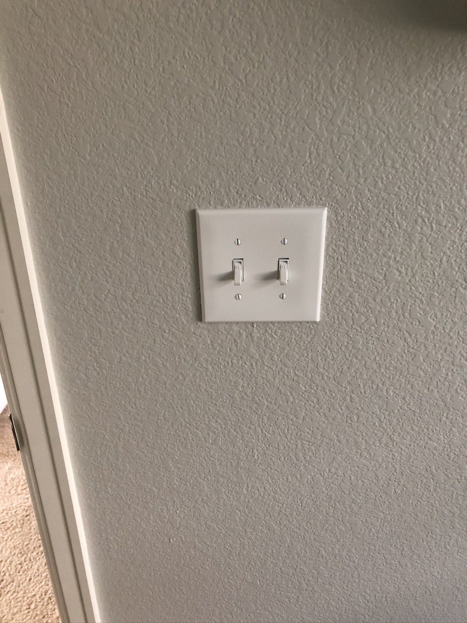 Close up of finger is turning on or off on light switch.