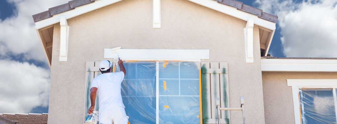 Professional painting the exterior of a window