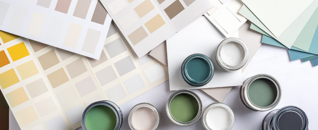 green and blue open pots of paint and beige colour swatches 