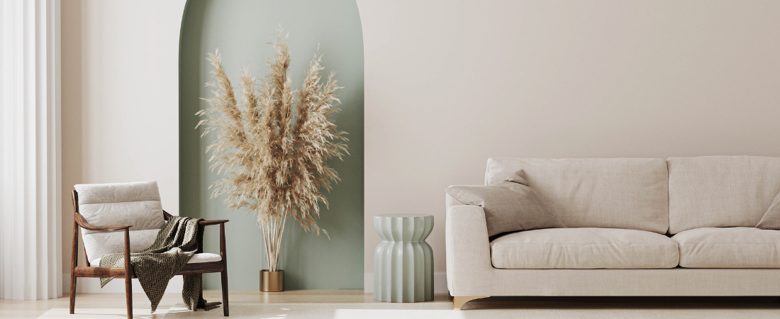 beige couch and chair in front of green and beige wall
