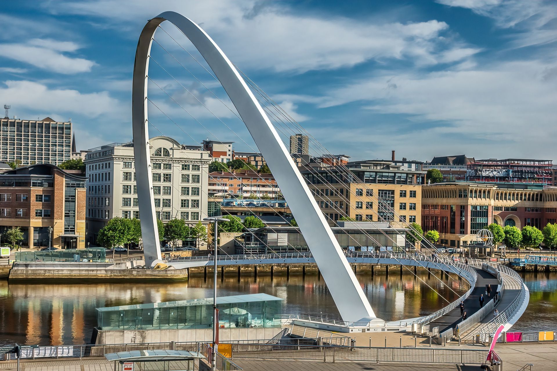 A large arch bridge over a body of water in a city.