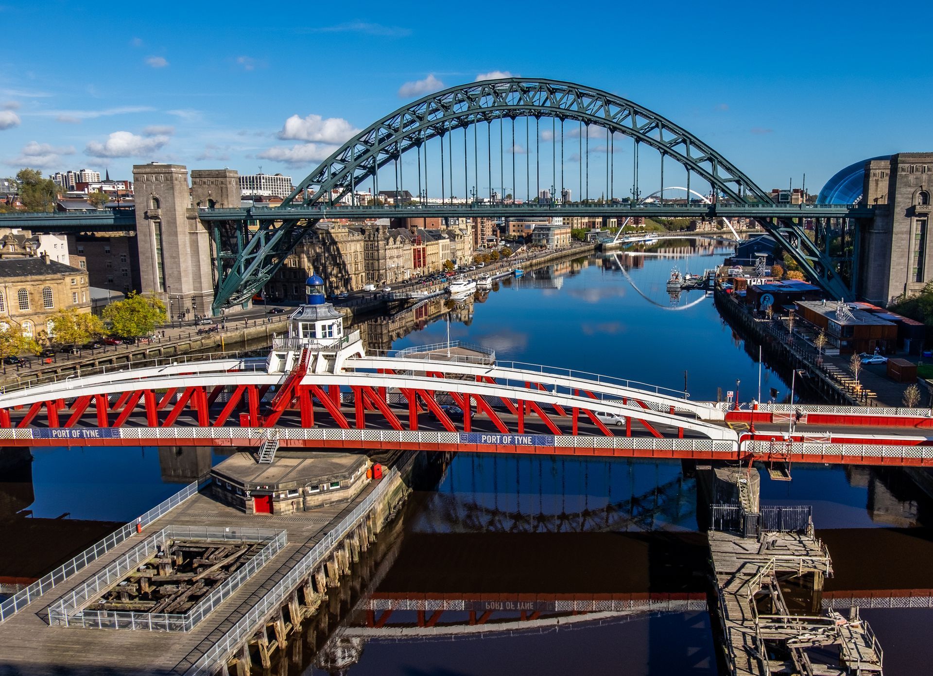 An aerial view of a bridge over a river in a city.