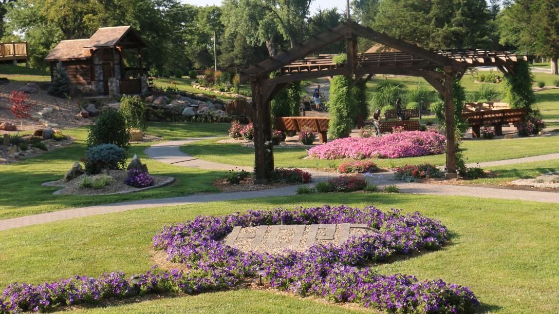 A park with purple flowers in the shape of a heart.