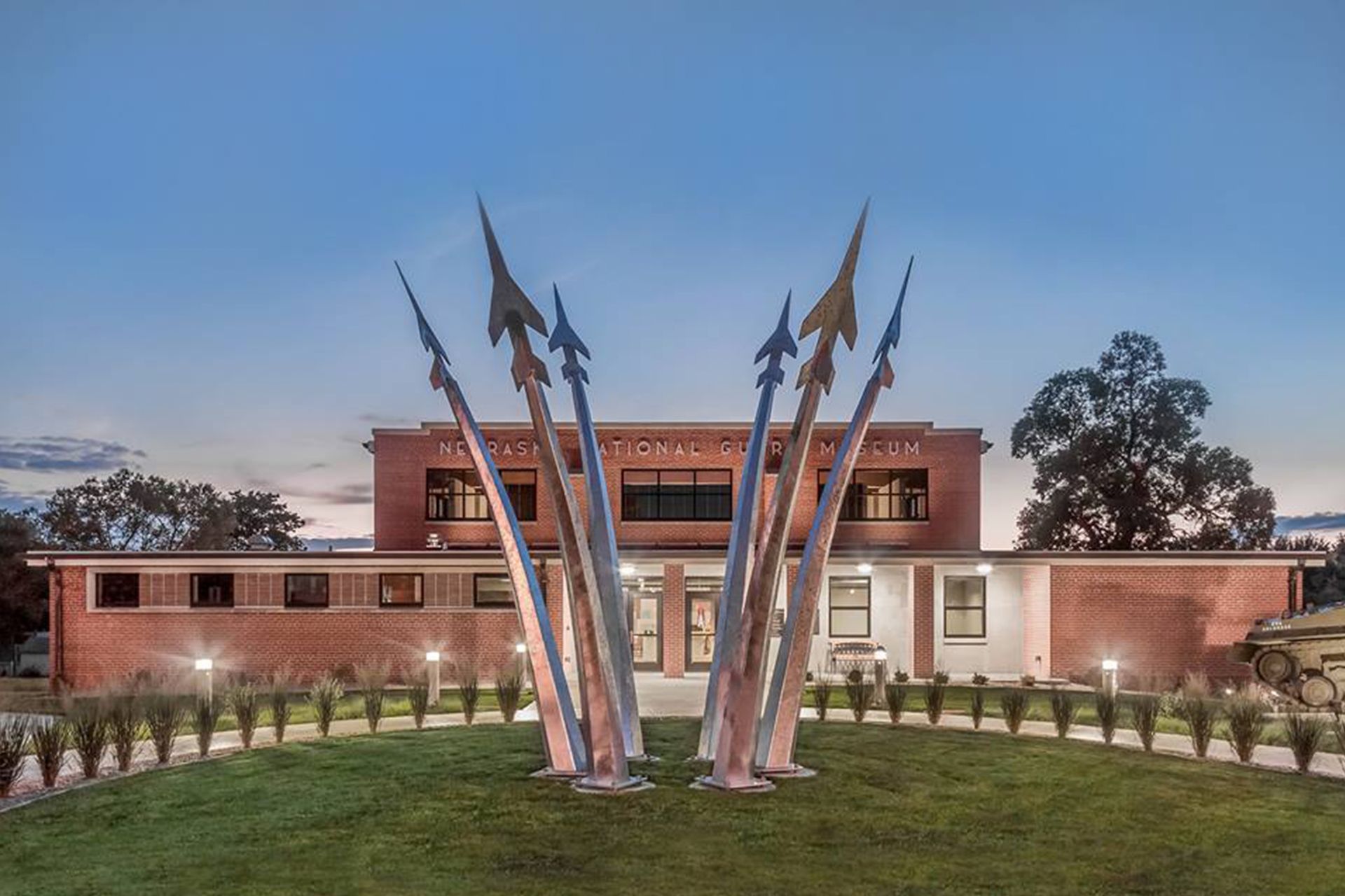 A brick building with a sculpture in front of it