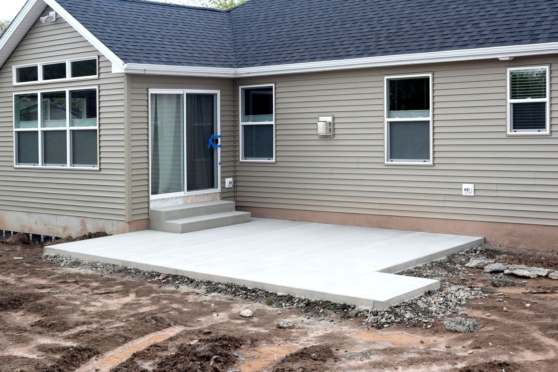 A house with a concrete patio in front of it.