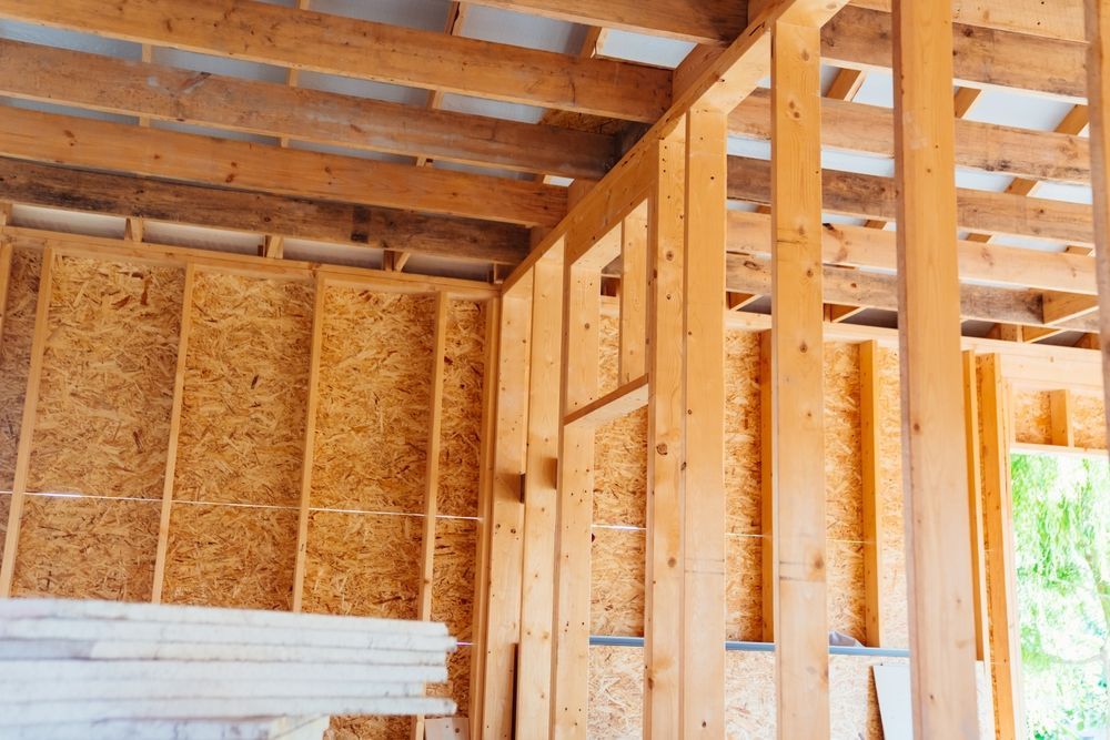 The inside of a house under construction with wooden beams.
