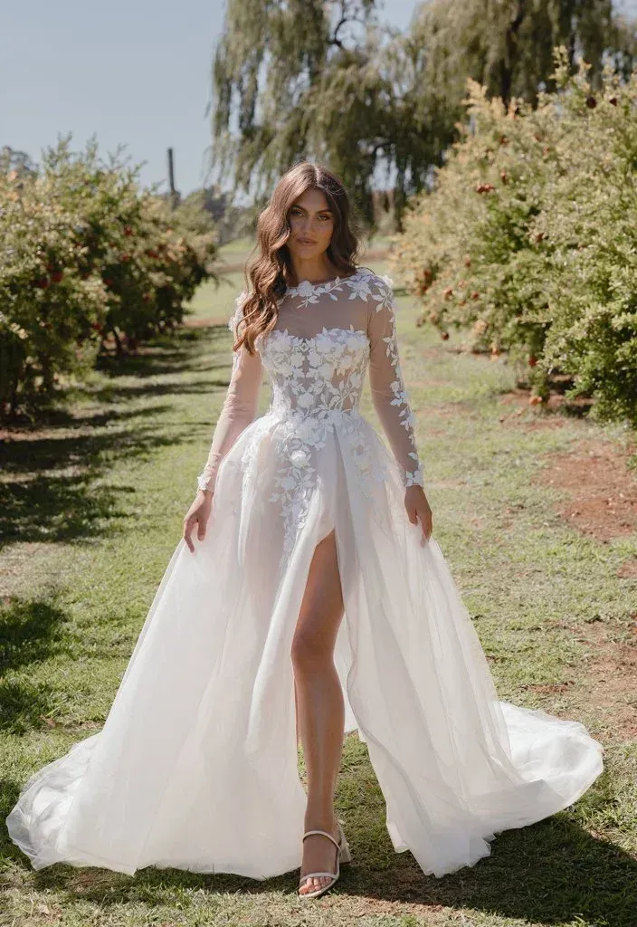Woman in white wedding dress with floral bodice and thigh-high slit, walking outdoors.