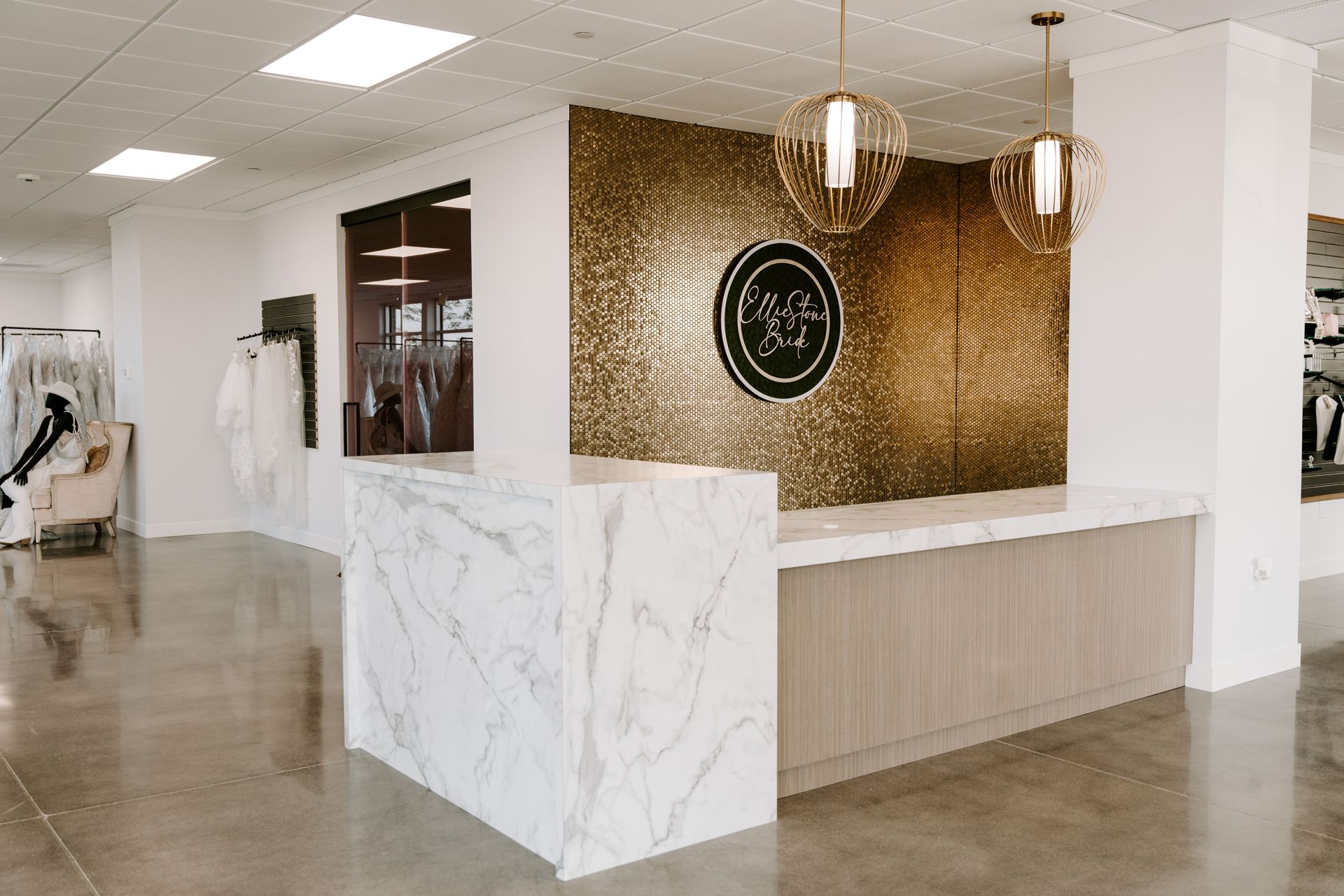 Reception area with marble counter and gold textured wall.