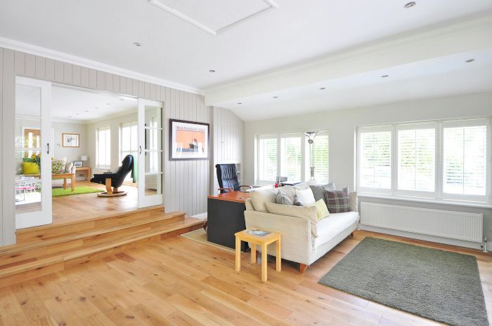 A living room with a couch , chair , table and rug.