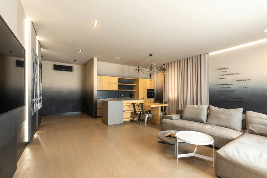 A living room with a couch , table , and television.