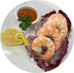 A plate of shrimp on ice with sauce and lemon slices