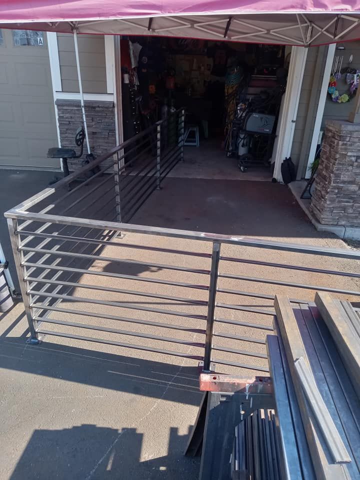 A metal railing is sitting in front of a garage.