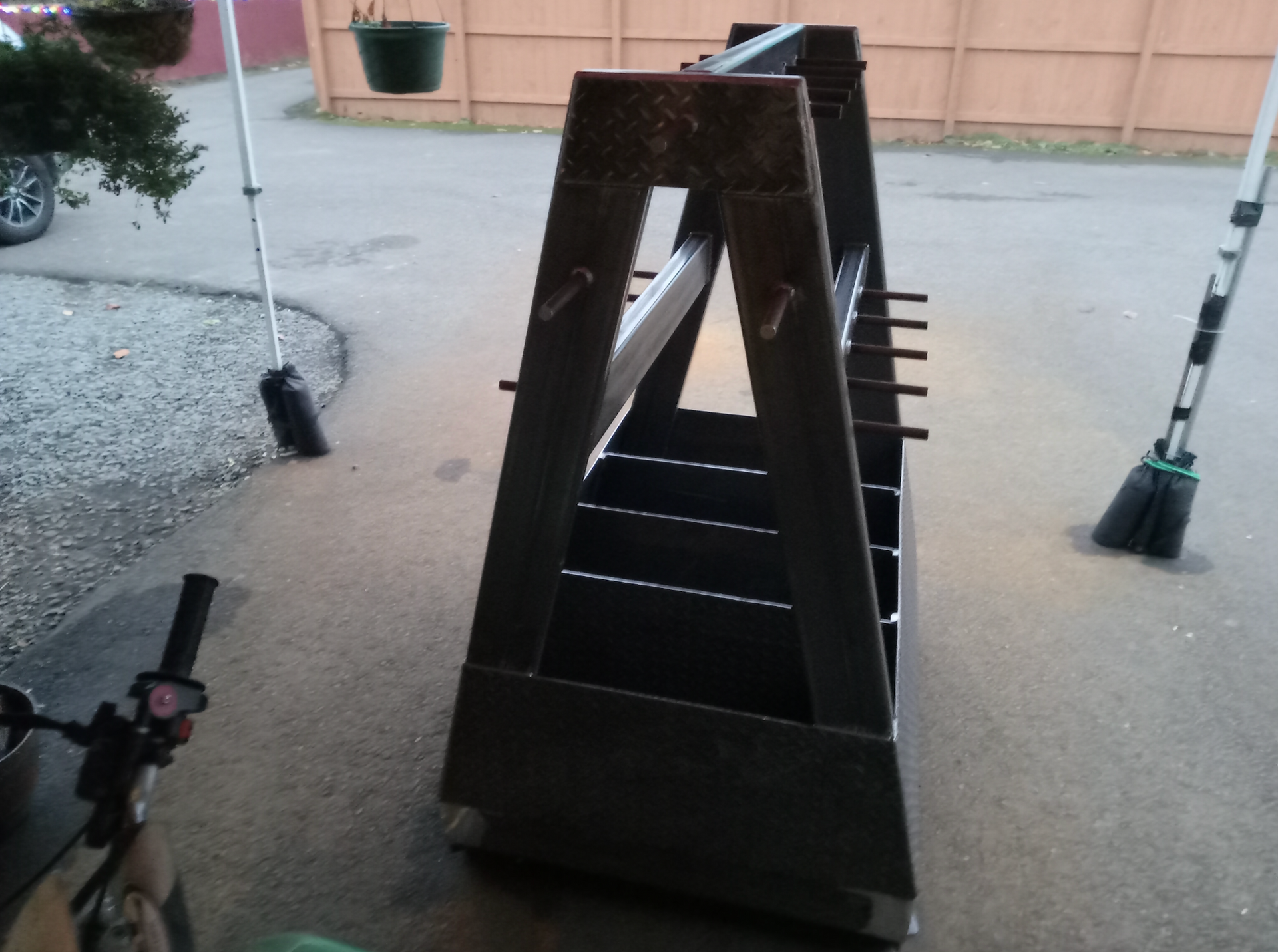 A bicycle is parked next to a wooden ladder