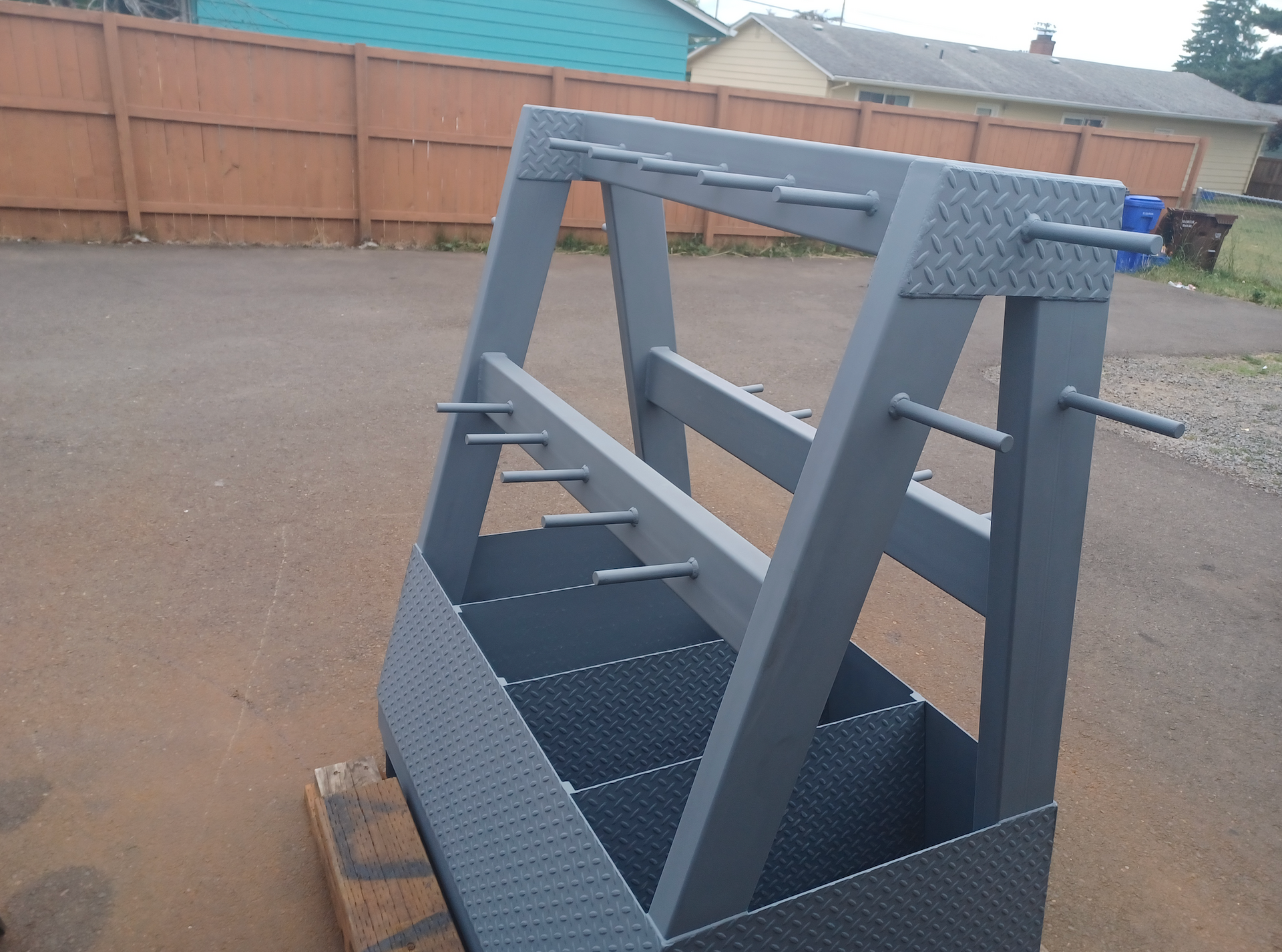 A gray metal structure with a fence in the background