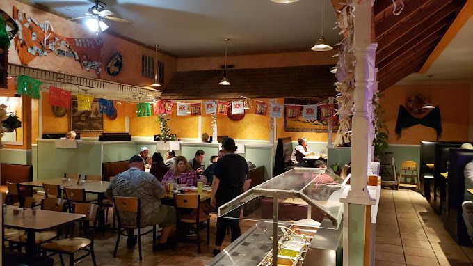 A group of people are sitting at tables in a restaurant.