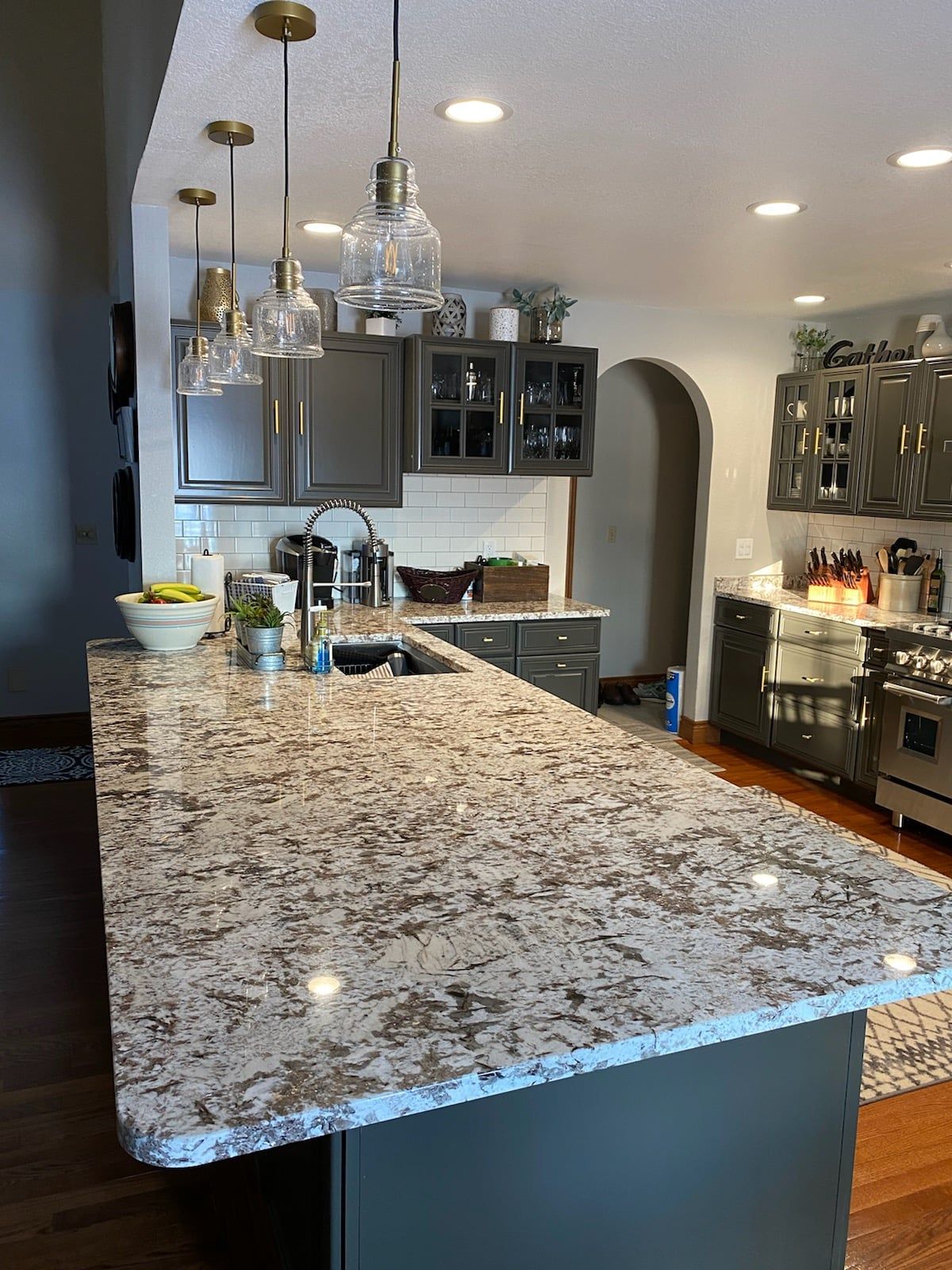A kitchen with a large granite counter top and stainless steel appliances - Luther Falls Kitchen & Bath - Champaign, IL