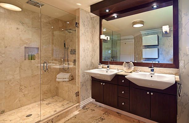 A bathroom with two sinks and a walk in shower - Luther Falls Kitchen & Bath - Champaign, IL