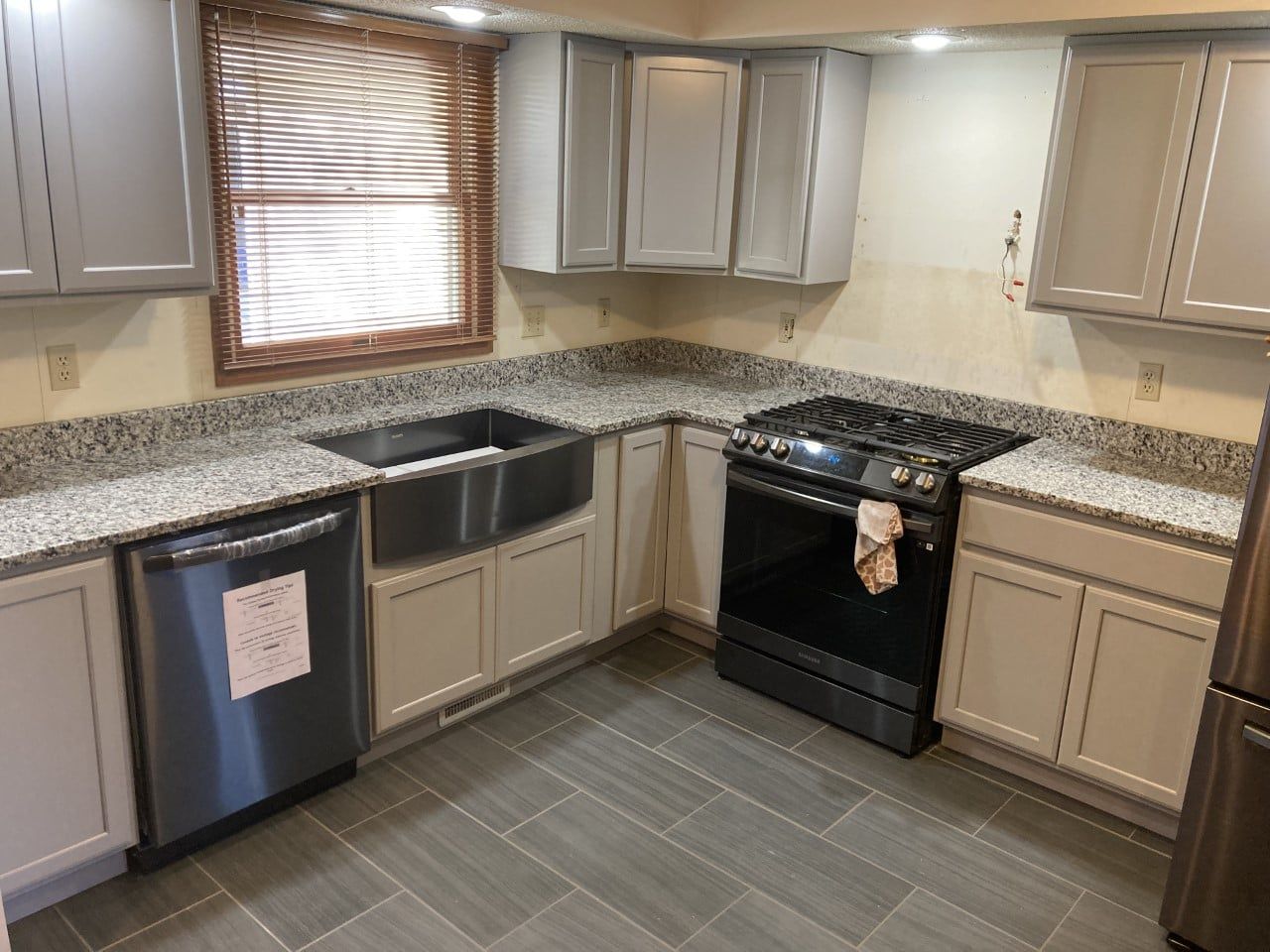 A kitchen with stainless steel appliances and granite counter tops - Luther Falls Kitchen & Bath - Champaign, IL