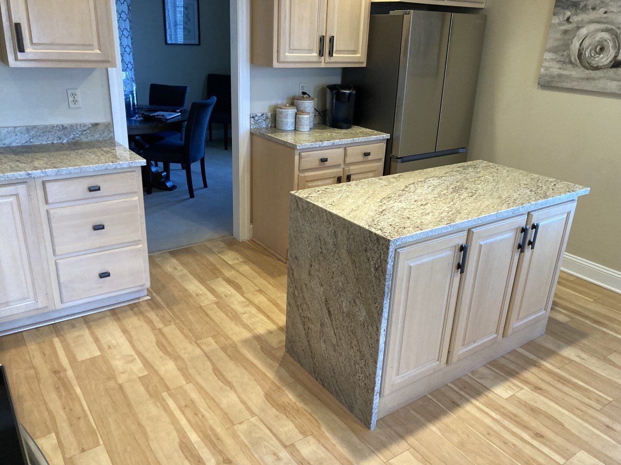 A kitchen with a large island in the middle of it - Luther Falls Kitchen & Bath - Champaign, IL