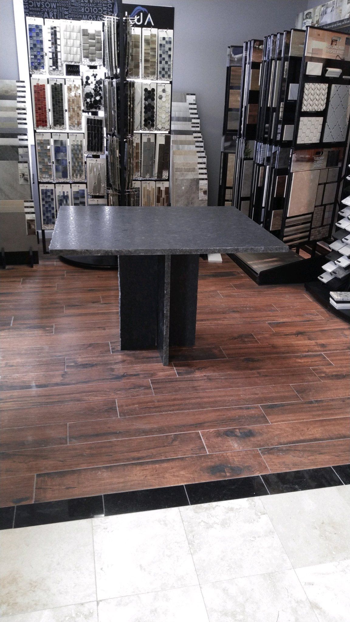 A table in a room with a wooden floor - Luther Falls Kitchen & Bath - Champaign, IL