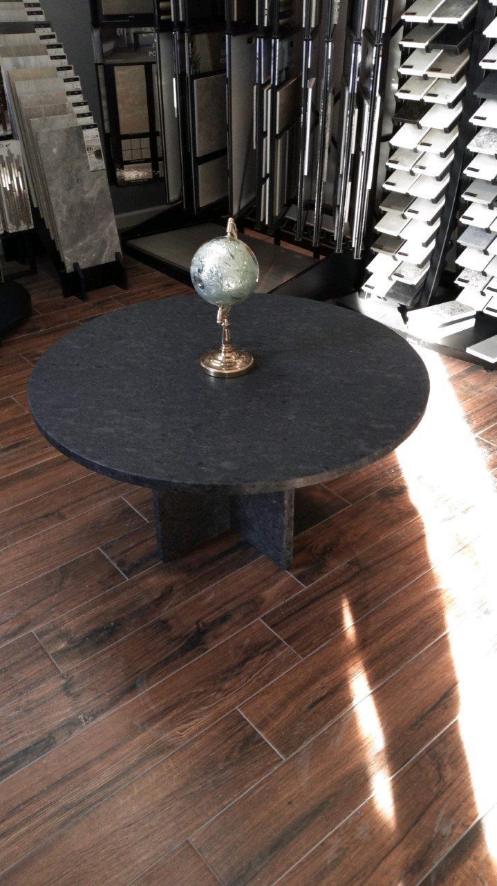 A round table with a globe on top of it in a room - Luther Falls Kitchen & Bath - Champaign, IL