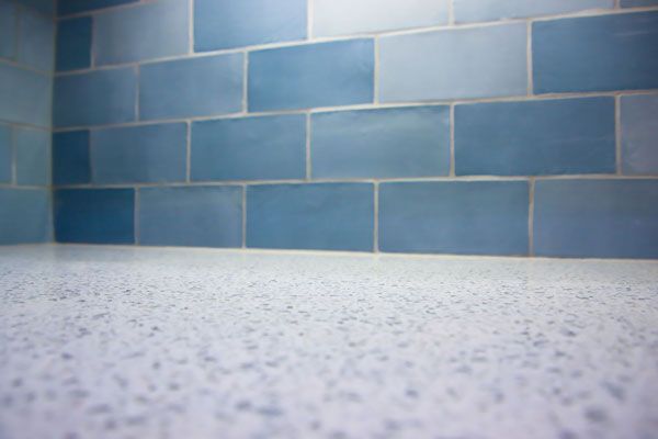 Quartz kitchen countertops with blue tile backsplash. Durable and stylish quartz surfaces for modern kitchens. - Luther Falls Kitchen & Bath - Champaign, IL
