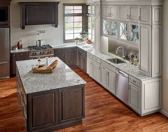 A kitchen with stainless steel appliances and granite counter tops- Luther Falls Kitchen & Bath - Champaign, IL