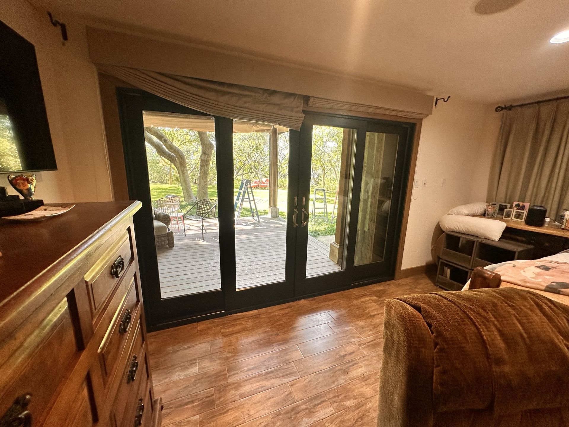 A living room with sliding glass doors leading to a deck.