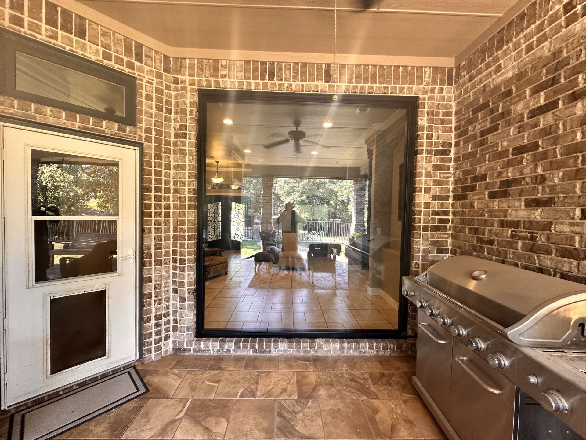 A kitchen with a grill and a large window.