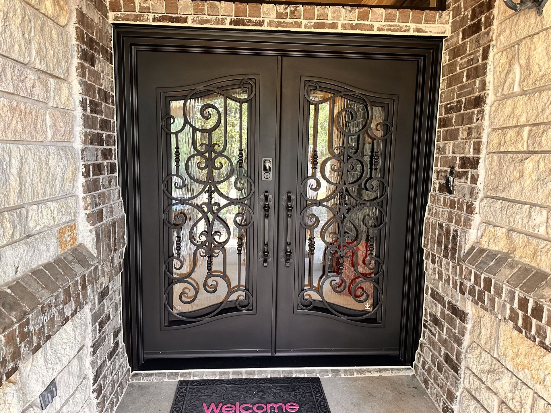 There is a welcome mat in front of the door.