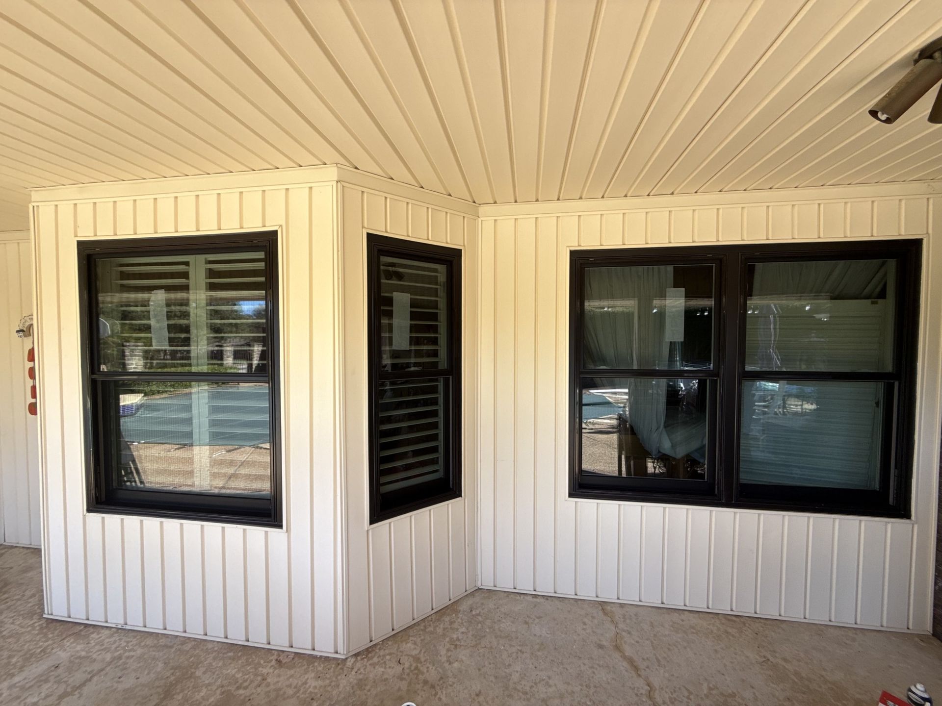 A white house with black windows and shutters